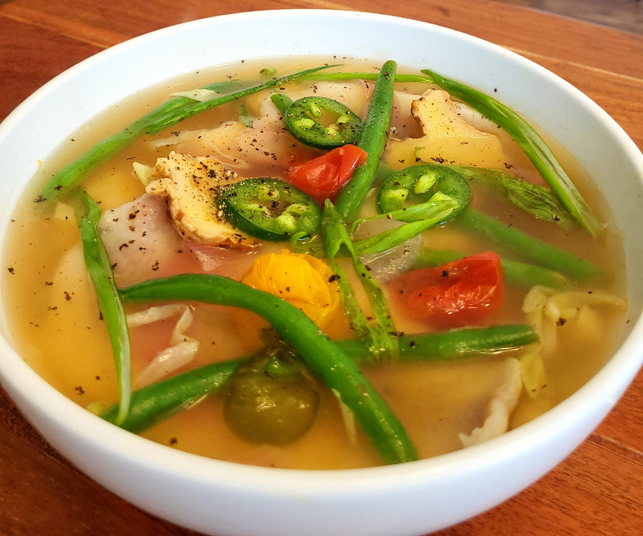 Bowl of sinigang-style sour soup representing Southern Luzon food traditions